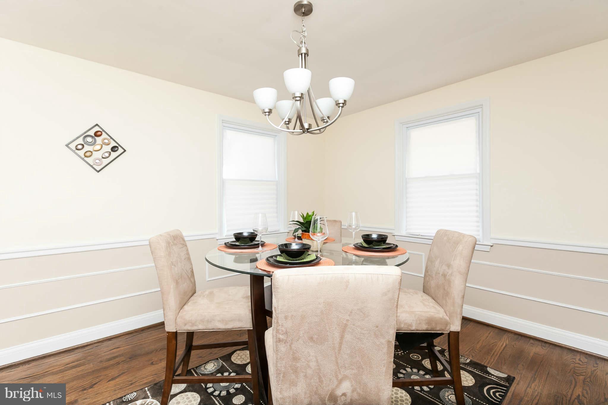 1316 East 35th Street Baltimore, MD 21218 - Photo 10 of 30 a dining room with furniture a rug and wooden floor