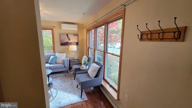 a kitchen that has a sink a stove and chairs
