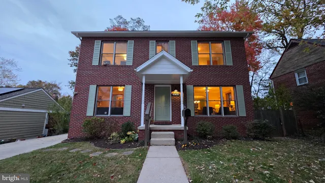 a view of a hallway with wooden floor and stairs