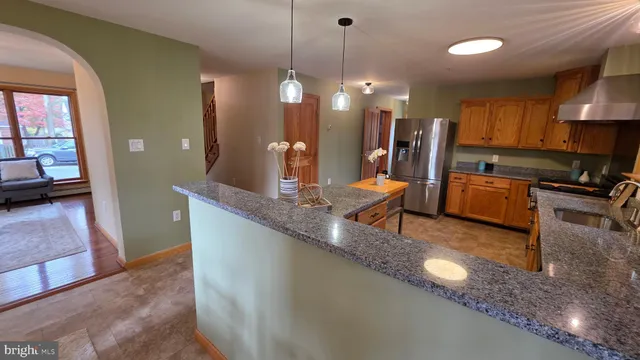 a view of an entryway with wooden floor and door