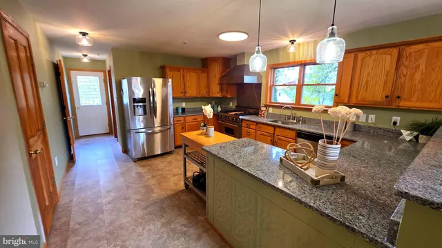 a view of a room with wooden floor and a window