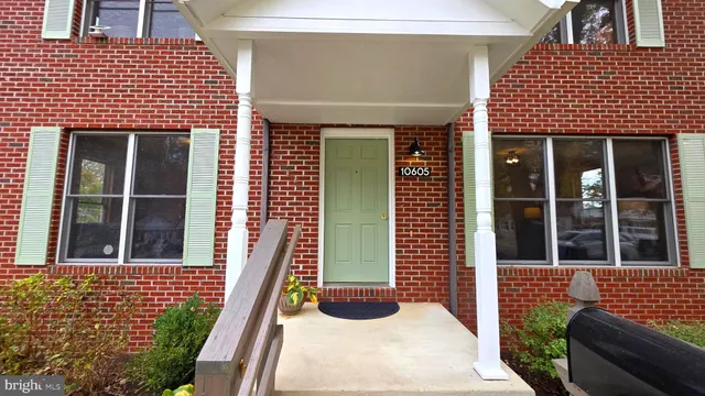 a living room with furniture and a lamp