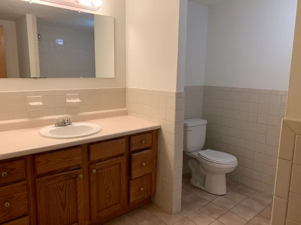 a bathroom with a sink toilet and a mirror