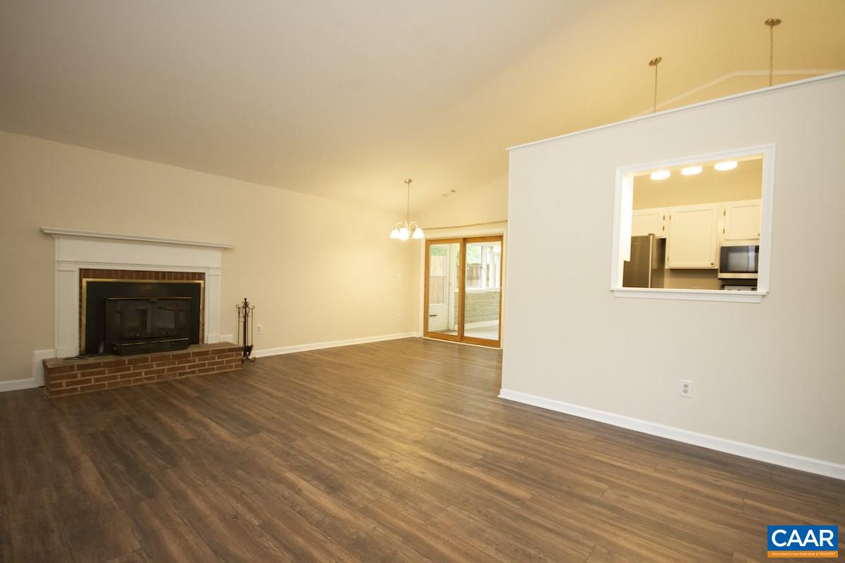 305 Minor Ridge Road Charlottesville, VA 22901 - Photo 9 of 27 a view of empty room with wooden floor and fireplace