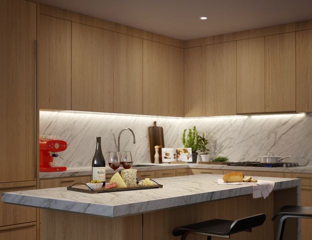 a kitchen with stainless steel appliances kitchen island granite countertop a sink and cabinets