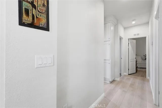 a view of a hallway with wooden floor
