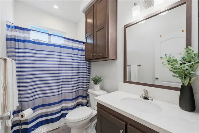 a bathroom with a sink toilet and mirror