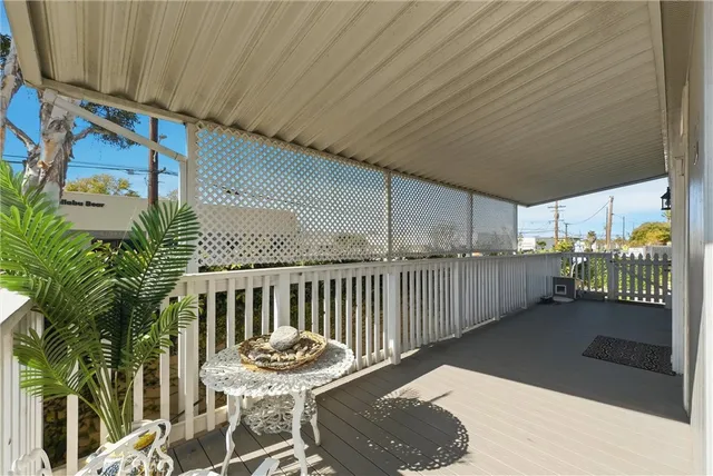 a balcony with table and chairs