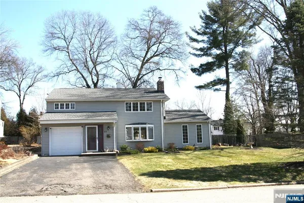 a view of house with a yard