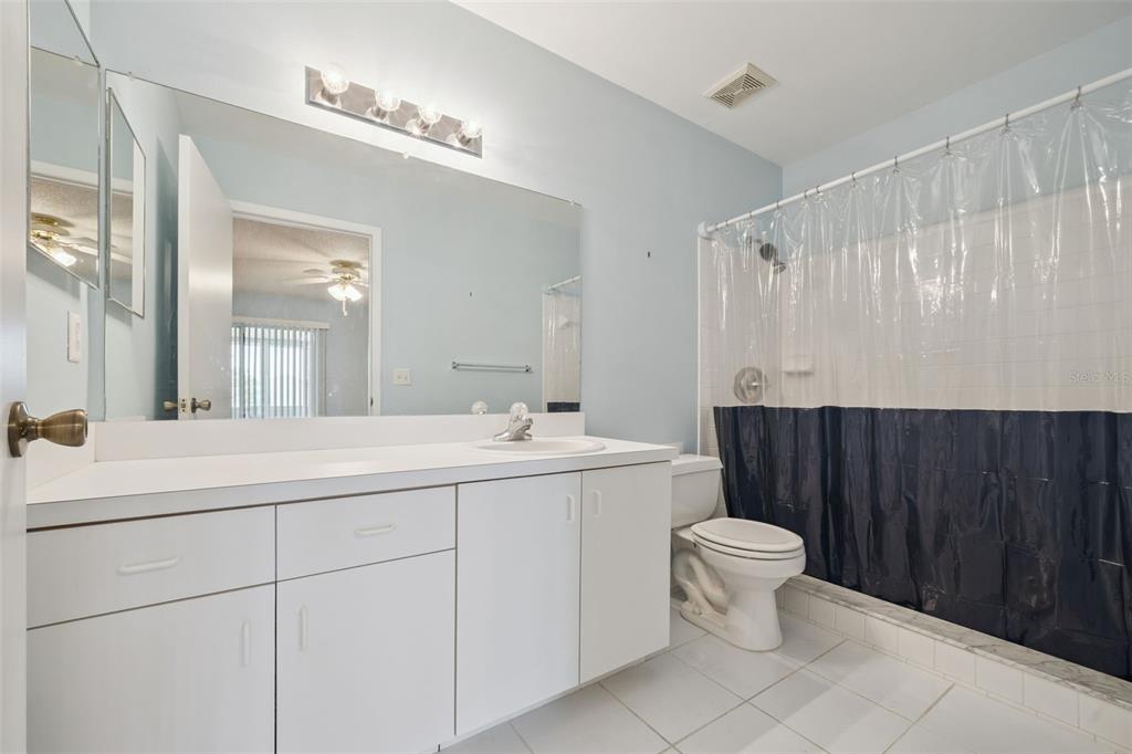 283 Winter Ridge Boulevard, Unit 283 Winter Haven, FL 33881 - Photo 12 of 20 a bathroom with a toilet sink and mirror
