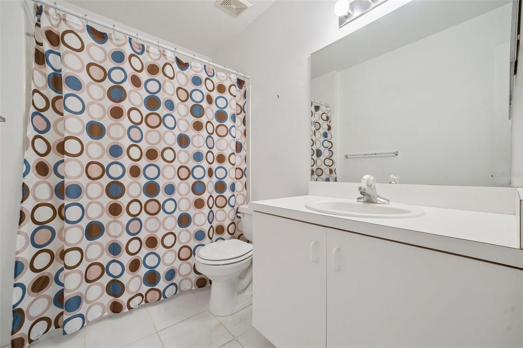 283 Winter Ridge Boulevard, Unit 283 Winter Haven, FL 33881 - Photo 14 of 20 a bathroom with a sink and mirror with toilet