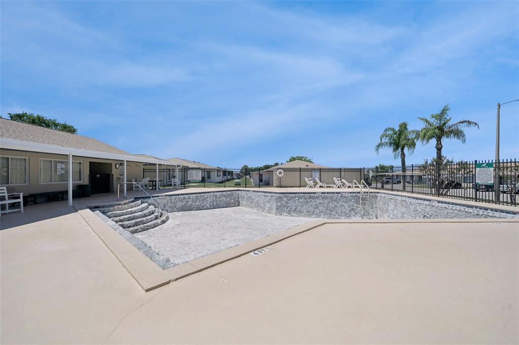 283 Winter Ridge Boulevard, Unit 283 Winter Haven, FL 33881 - Photo 19 of 20 a view of a swimming pool with an outdoor seating and a shower view