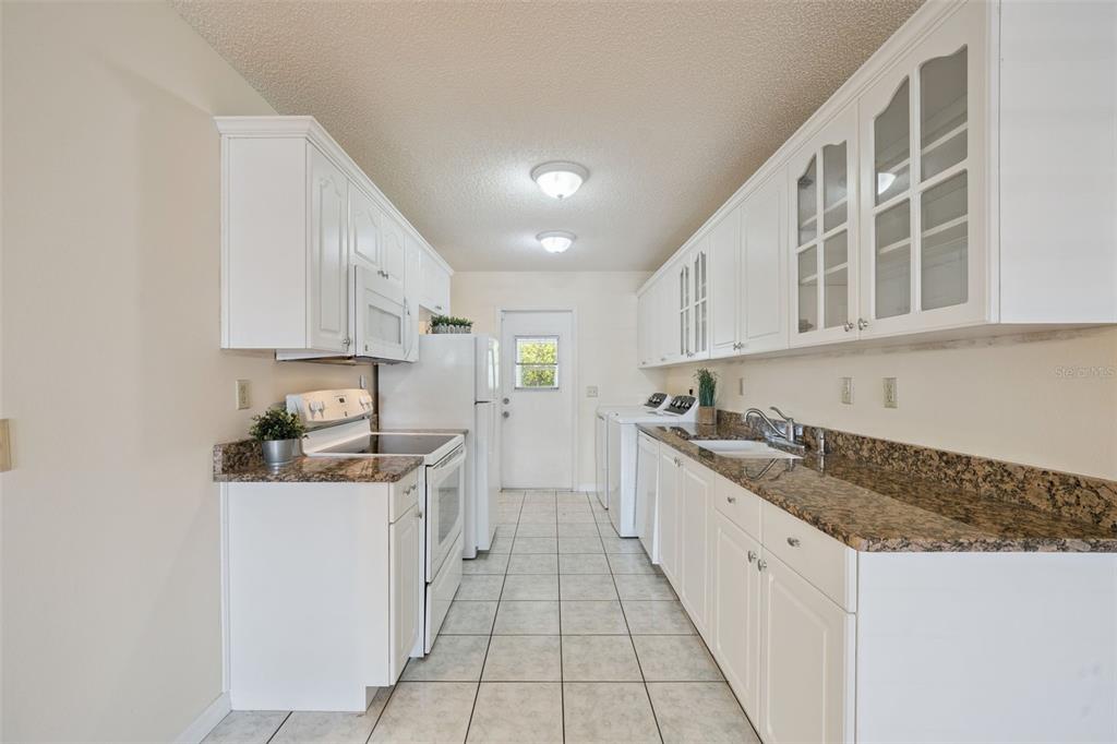 283 Winter Ridge Boulevard, Unit 283 Winter Haven, FL 33881 - Photo 8 of 20 a kitchen with stainless steel appliances granite countertop a sink and cabinets