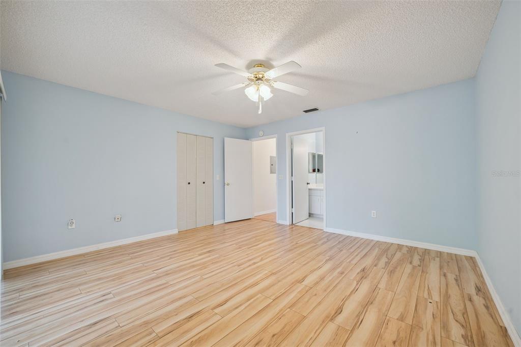 283 Winter Ridge Boulevard, Unit 283 Winter Haven, FL 33881 - Photo 10 of 20 a view of an empty room with wooden floor