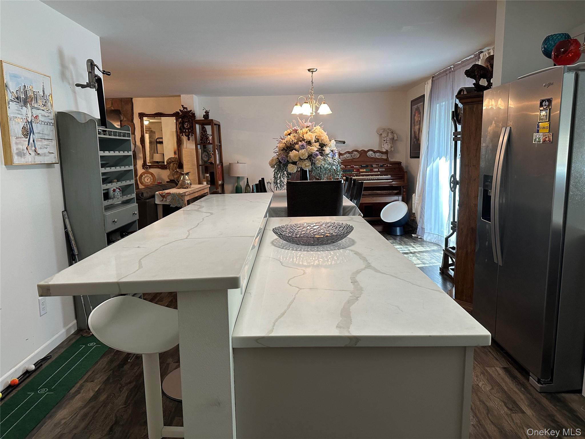 64 Schleiermacher Road Livingston Manor, NY 12758 - Photo 12 of 37 a kitchen with stainless steel appliances a dining table chairs and refrigerator
