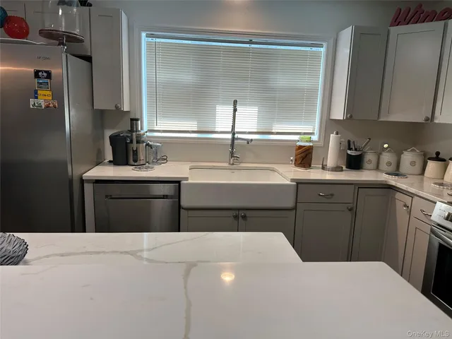 a kitchen with a sink dishwasher a refrigerator and cabinets