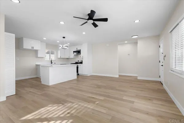 a view of kitchen with stove top oven and cabinets