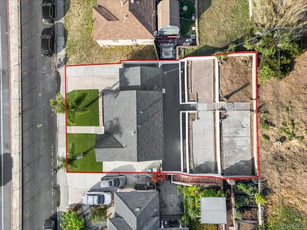 an aerial view of a house with a yard and a fountain
