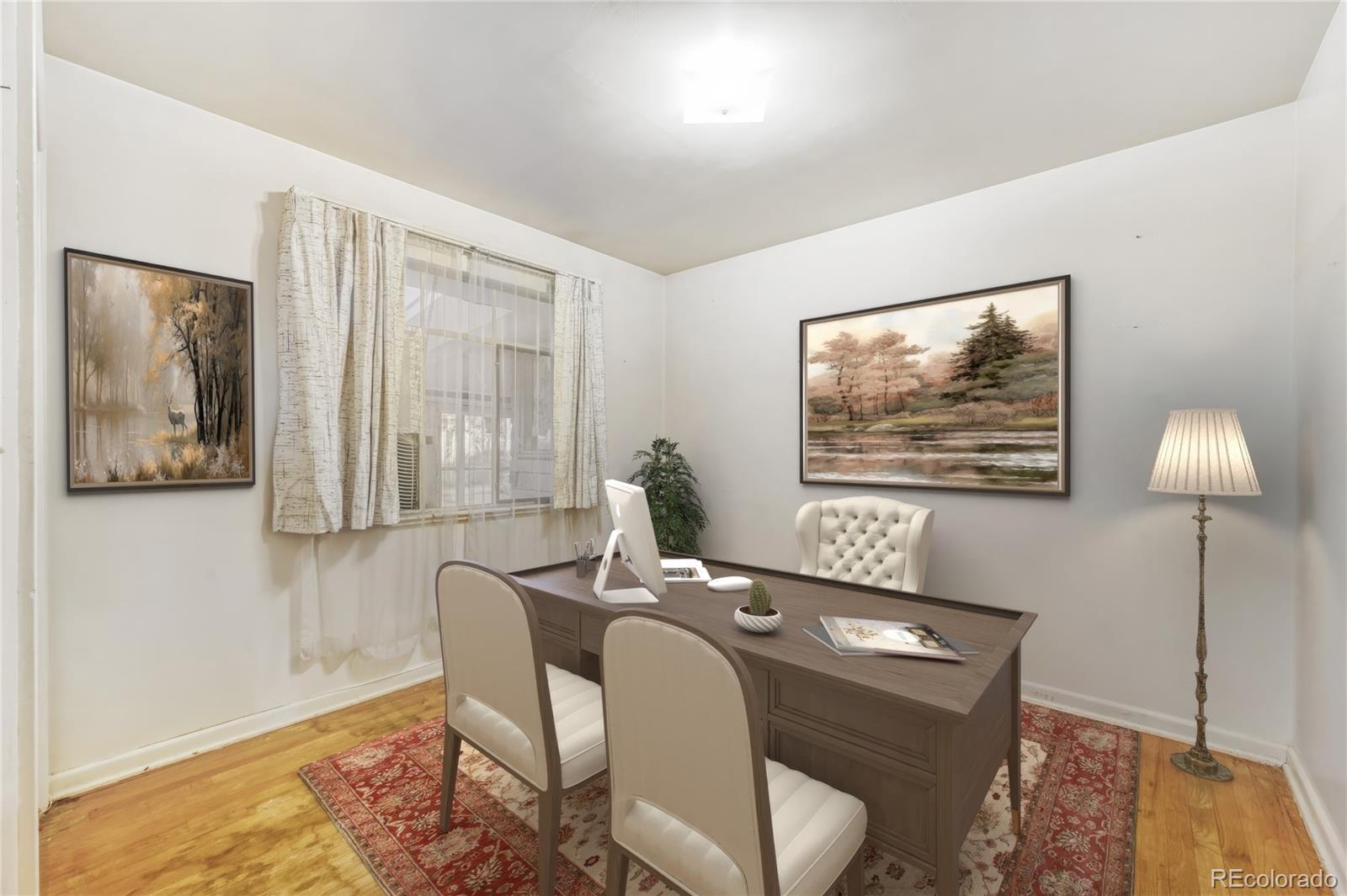 7850 Raleigh Street Westminster, CO 80030 - Photo 12 of 18 a view of a workspace room with furniture and wooden floor