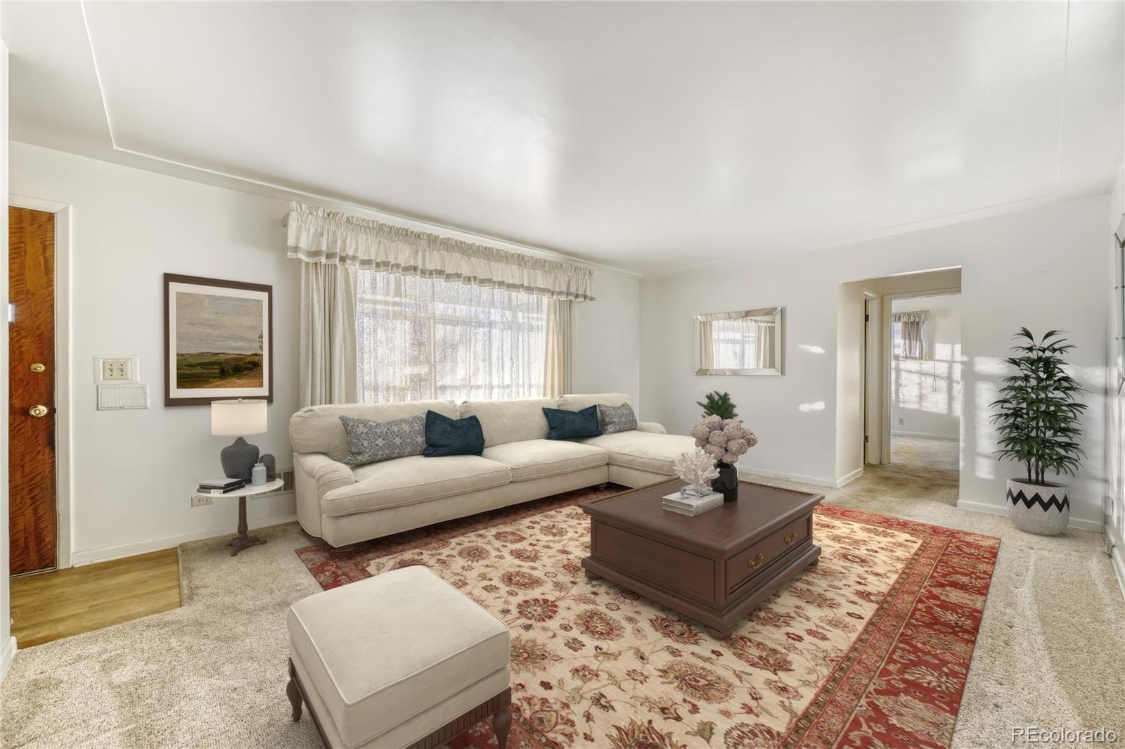 7850 Raleigh Street Westminster, CO 80030 - Photo 2 of 18 a living room with furniture and a couch