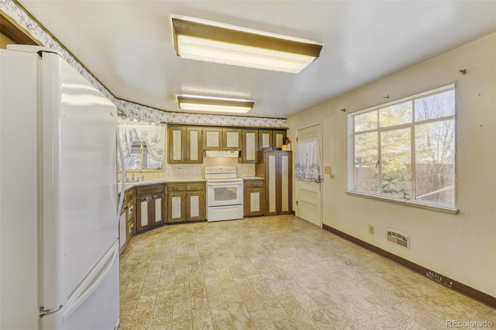 7850 Raleigh Street Westminster, CO 80030 - Photo 5 of 18 a view of an empty room with a window