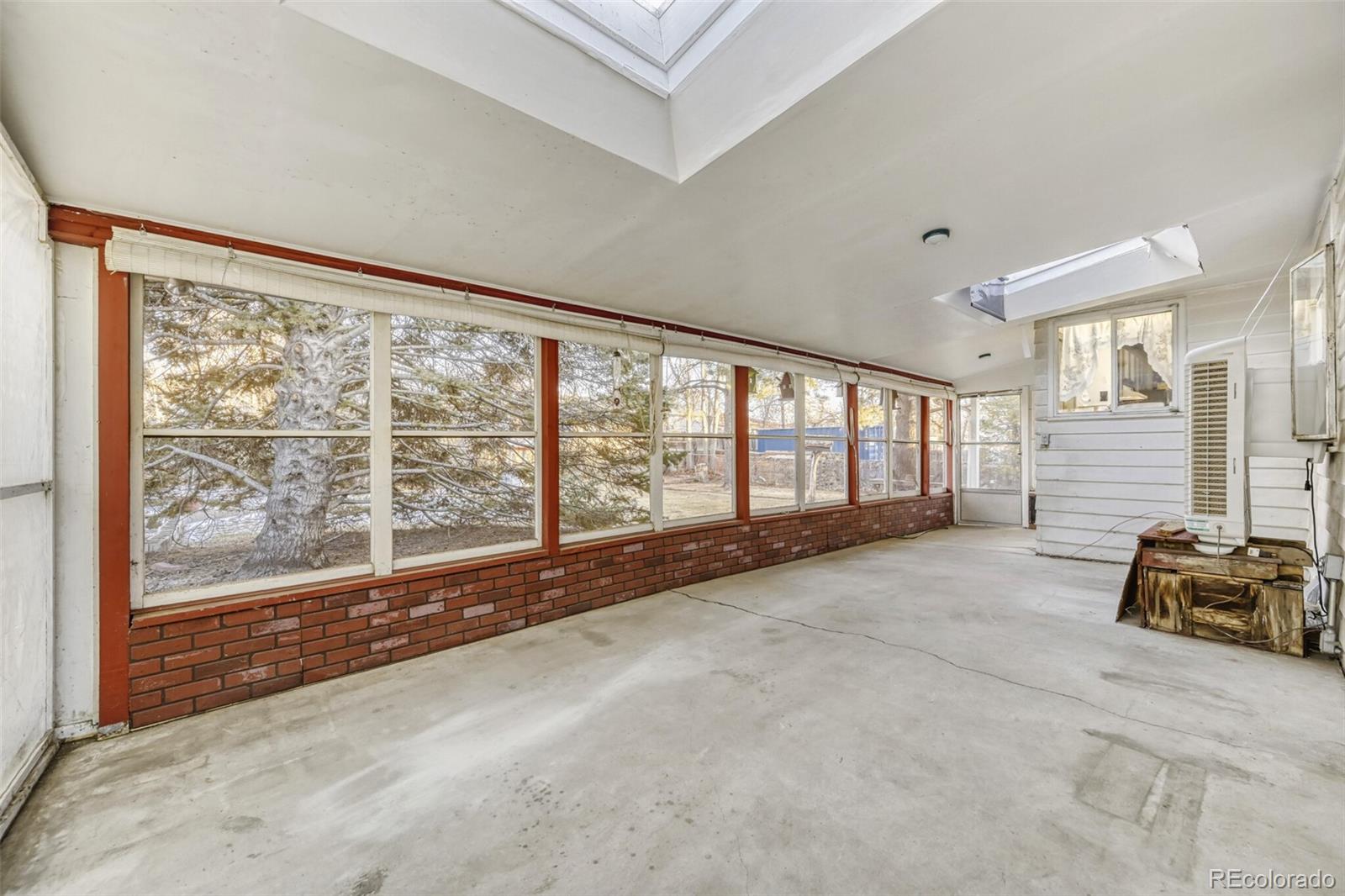 7850 Raleigh Street Westminster, CO 80030 - Photo 8 of 18 a big room with wooden floor and windows