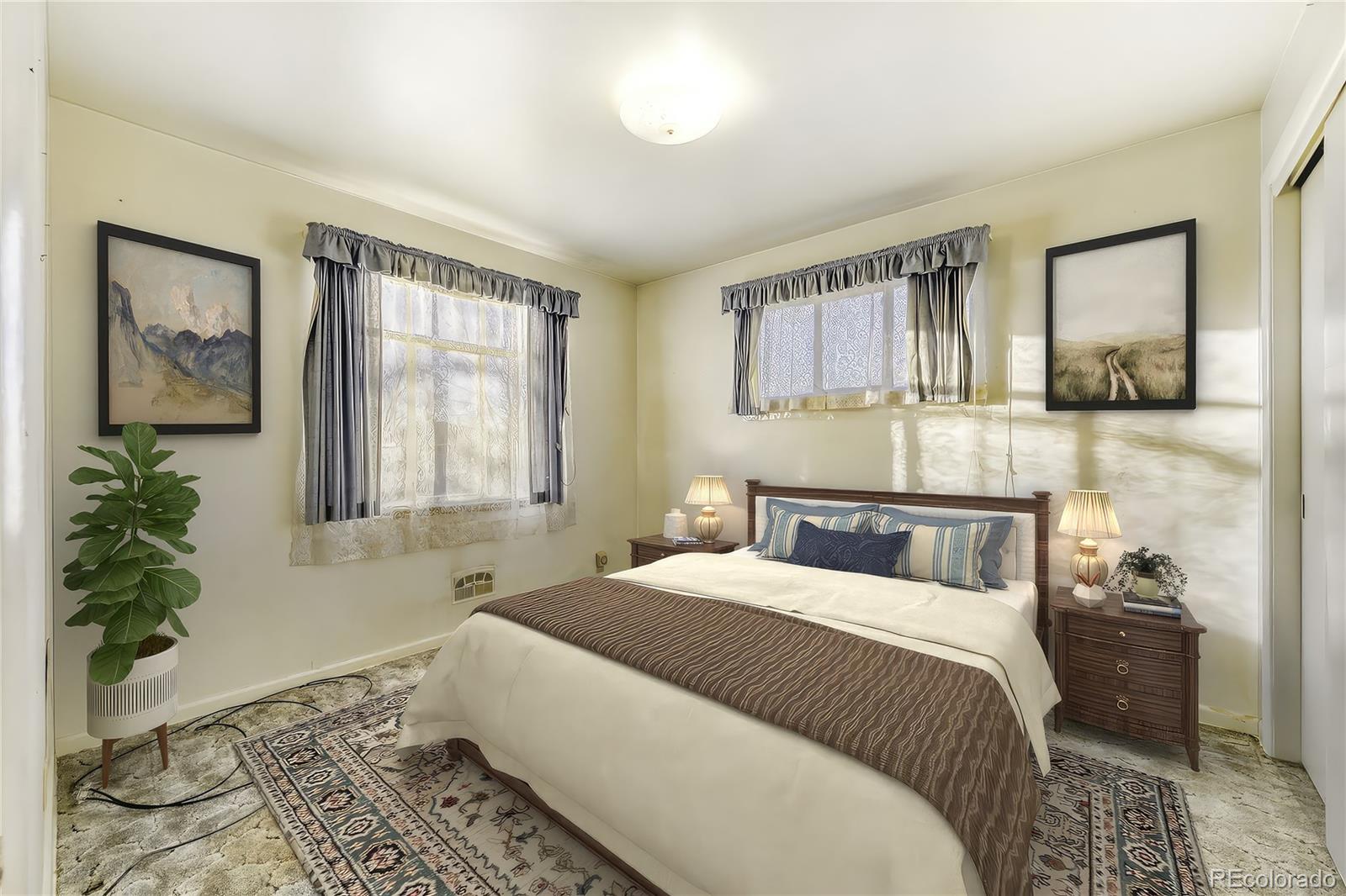 7850 Raleigh Street Westminster, CO 80030 - Photo 9 of 18 a bedroom with a bed and a potted plant