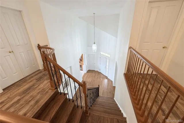 a view of entryway with wooden floor and stairs
