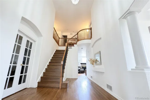 a view of entryway and hall with wooden floor
