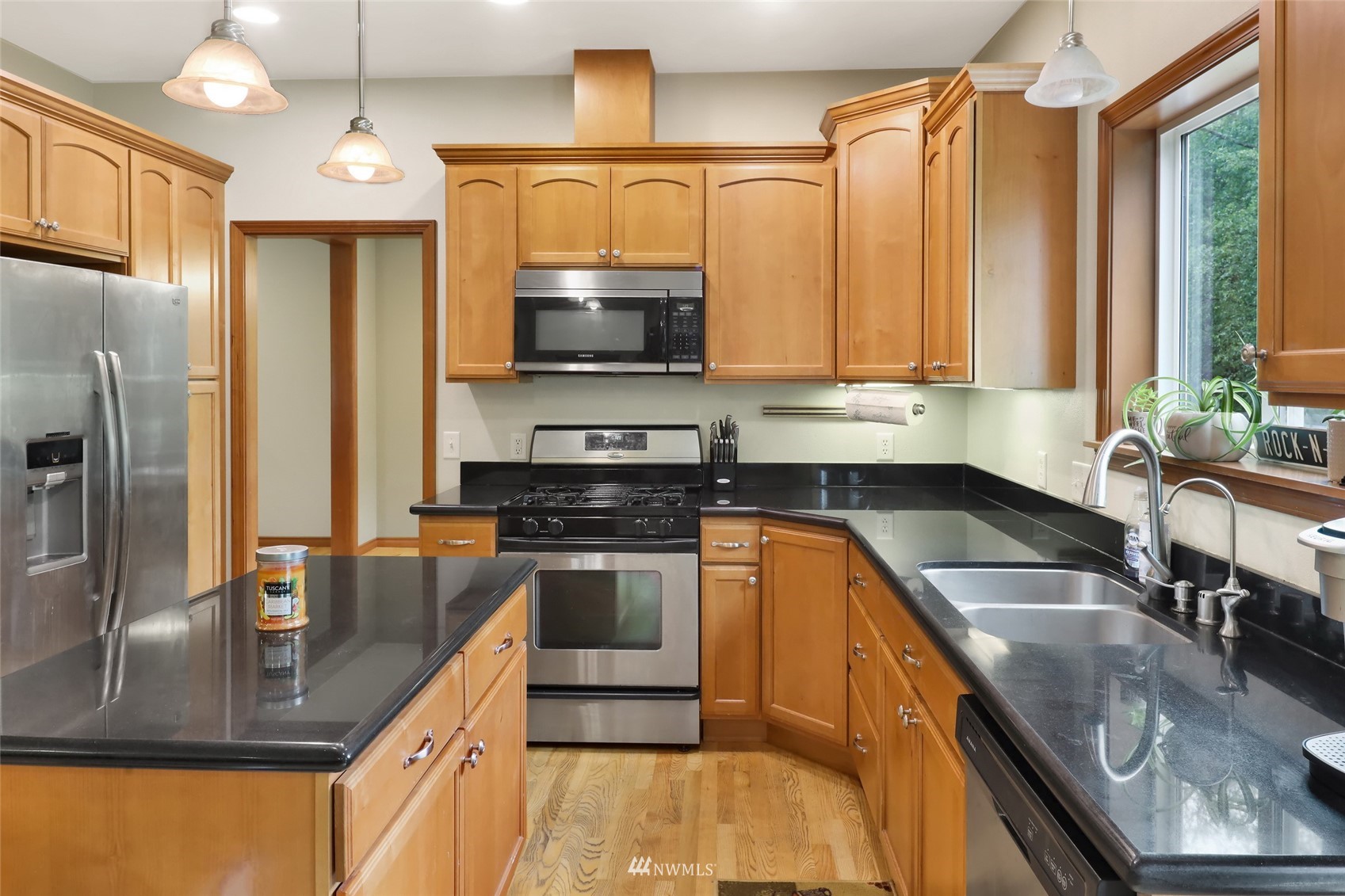 2708 Brown Road Ferndale, WA 98248 - Photo 18 of 38 a kitchen with stainless steel appliances granite countertop a sink a stove and a refrigerator