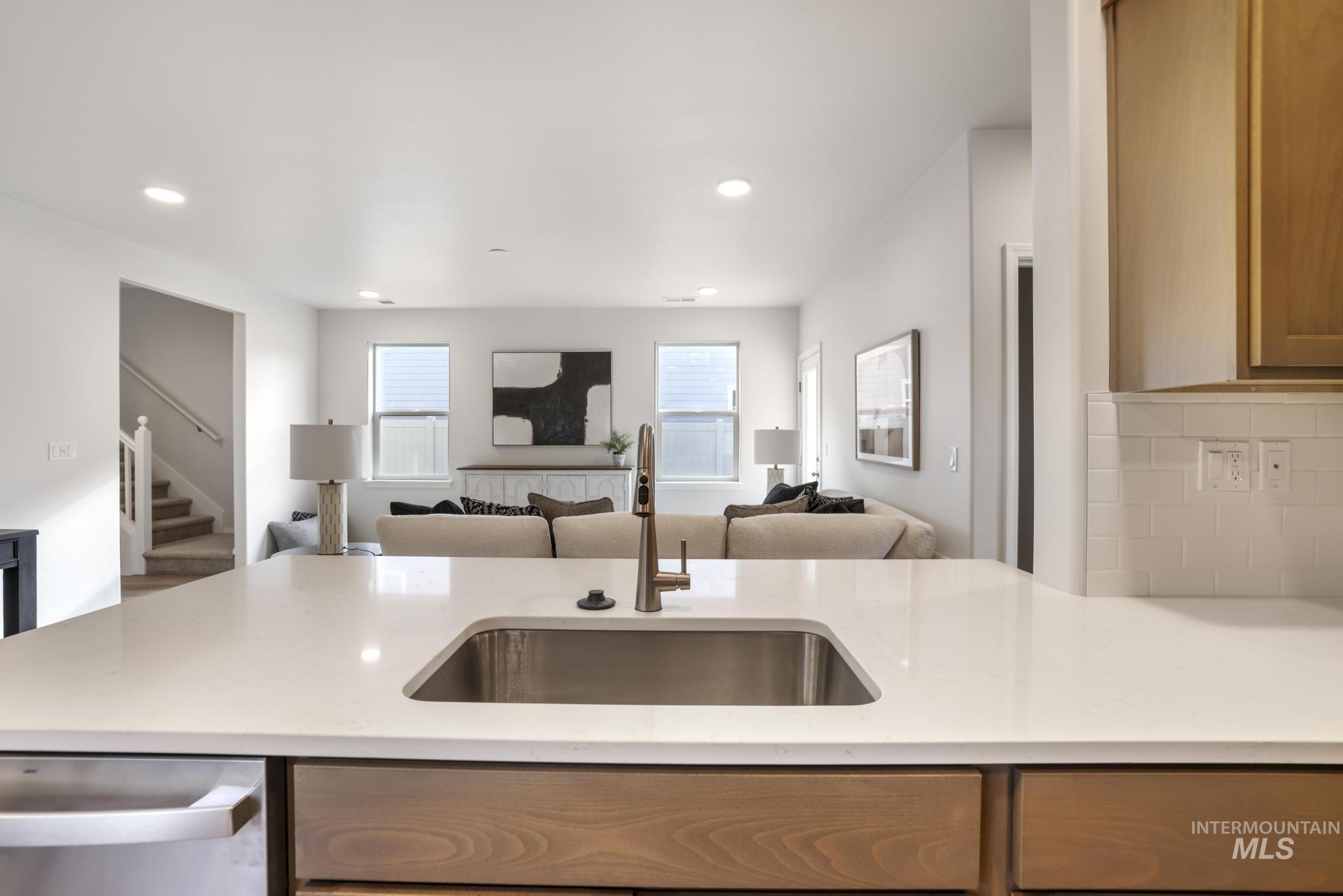 1542 Kenyon Road Twin Falls, ID 83301 - Photo 26 of 26 Kitchen featuring stainless steel dishwasher, light stone countertops, open floor plan, recessed lighting, and a peninsula