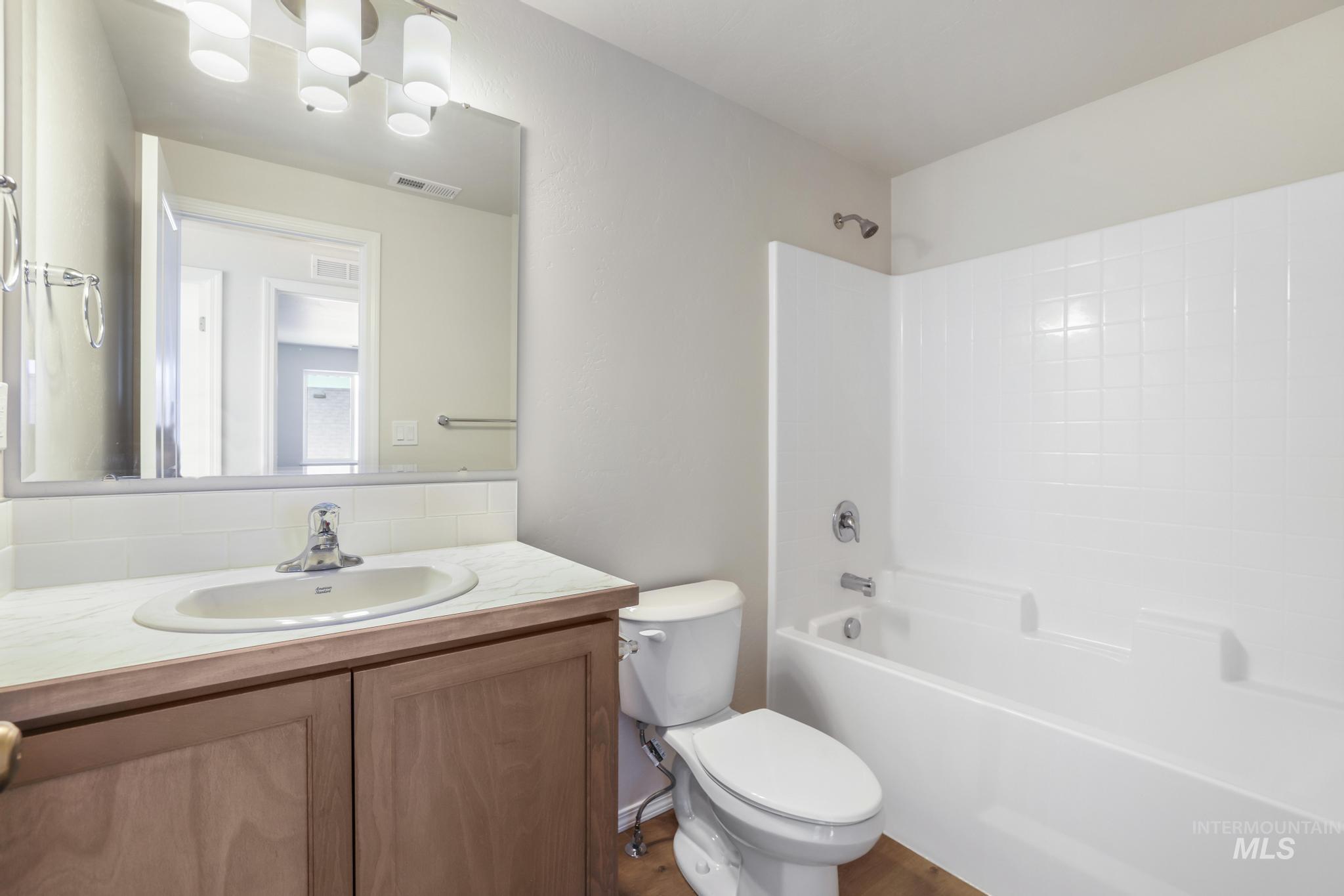 1542 Kenyon Road Twin Falls, ID 83301 - Photo 22 of 26 Bathroom featuring washtub / shower combination and vanity