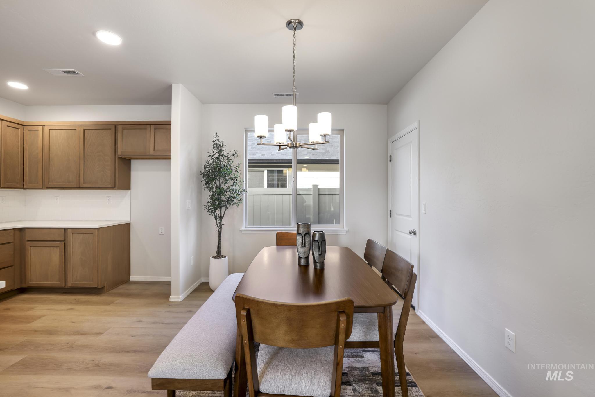 1542 Kenyon Road Twin Falls, ID 83301 - Photo 9 of 26 Dining area with light wood finished floors, a chandelier, and recessed lighting