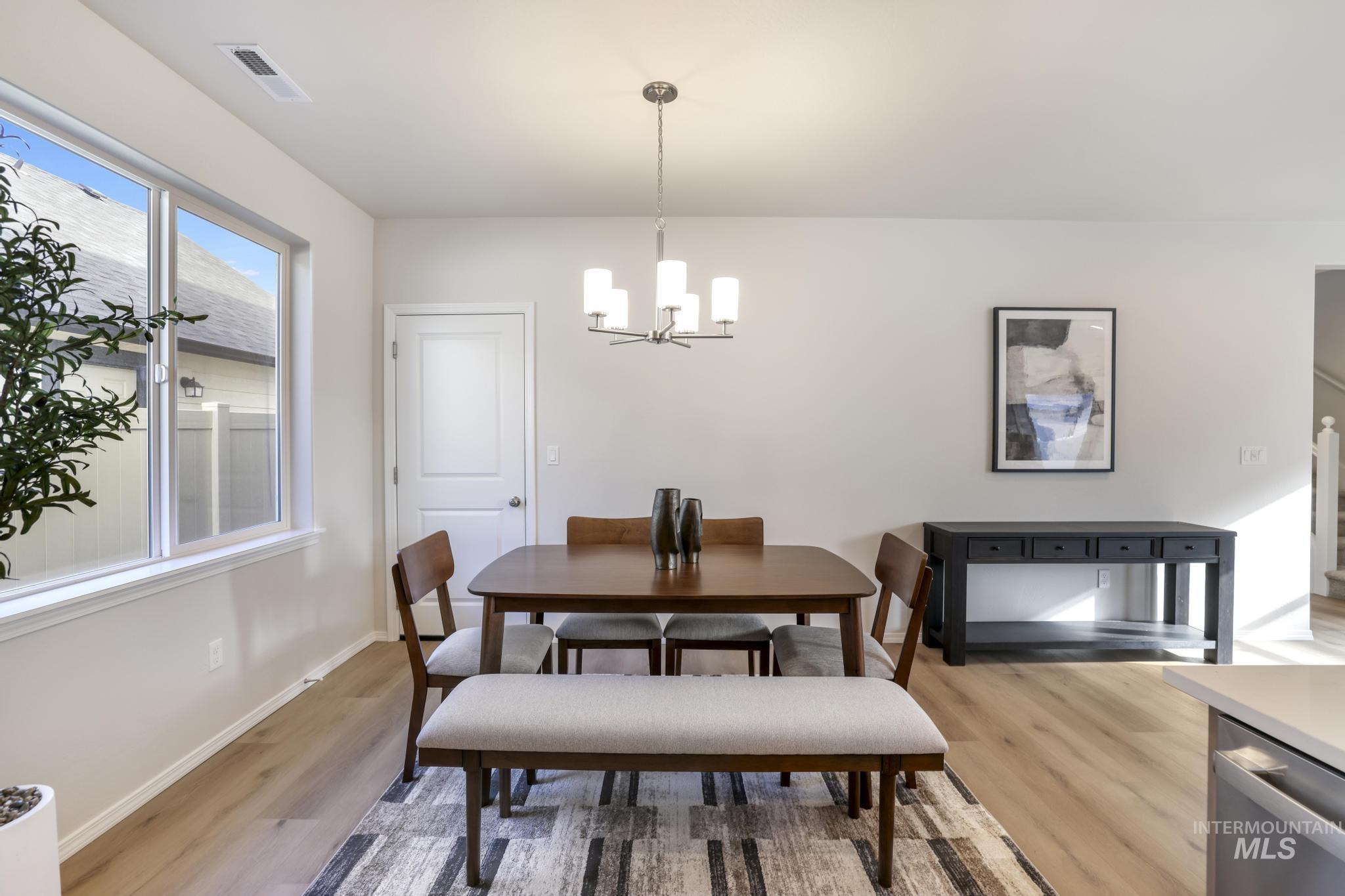 1542 Kenyon Road Twin Falls, ID 83301 - Photo 10 of 26 Dining room with a chandelier and light wood-style floors