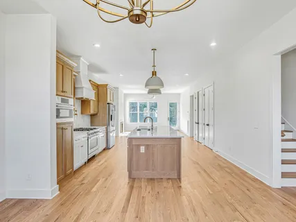 a kitchen with stainless steel appliances a refrigerator sink and cabinets