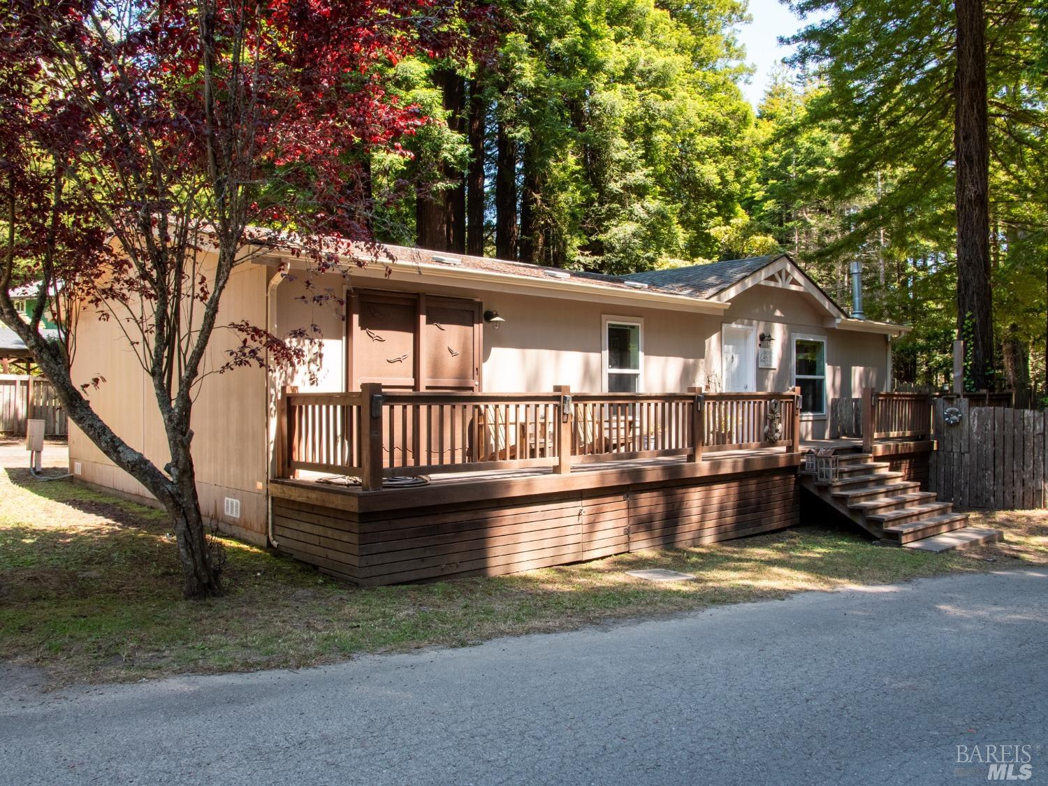 a view of a house with roof deck and a small yard