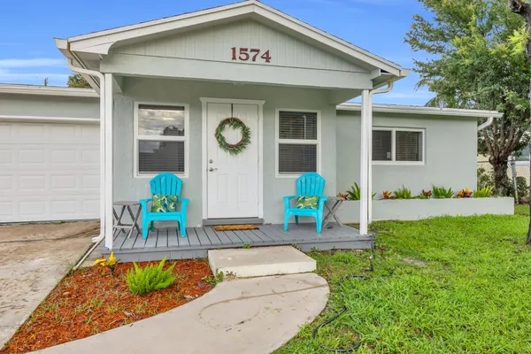 a front view of house with yard and outdoor seating