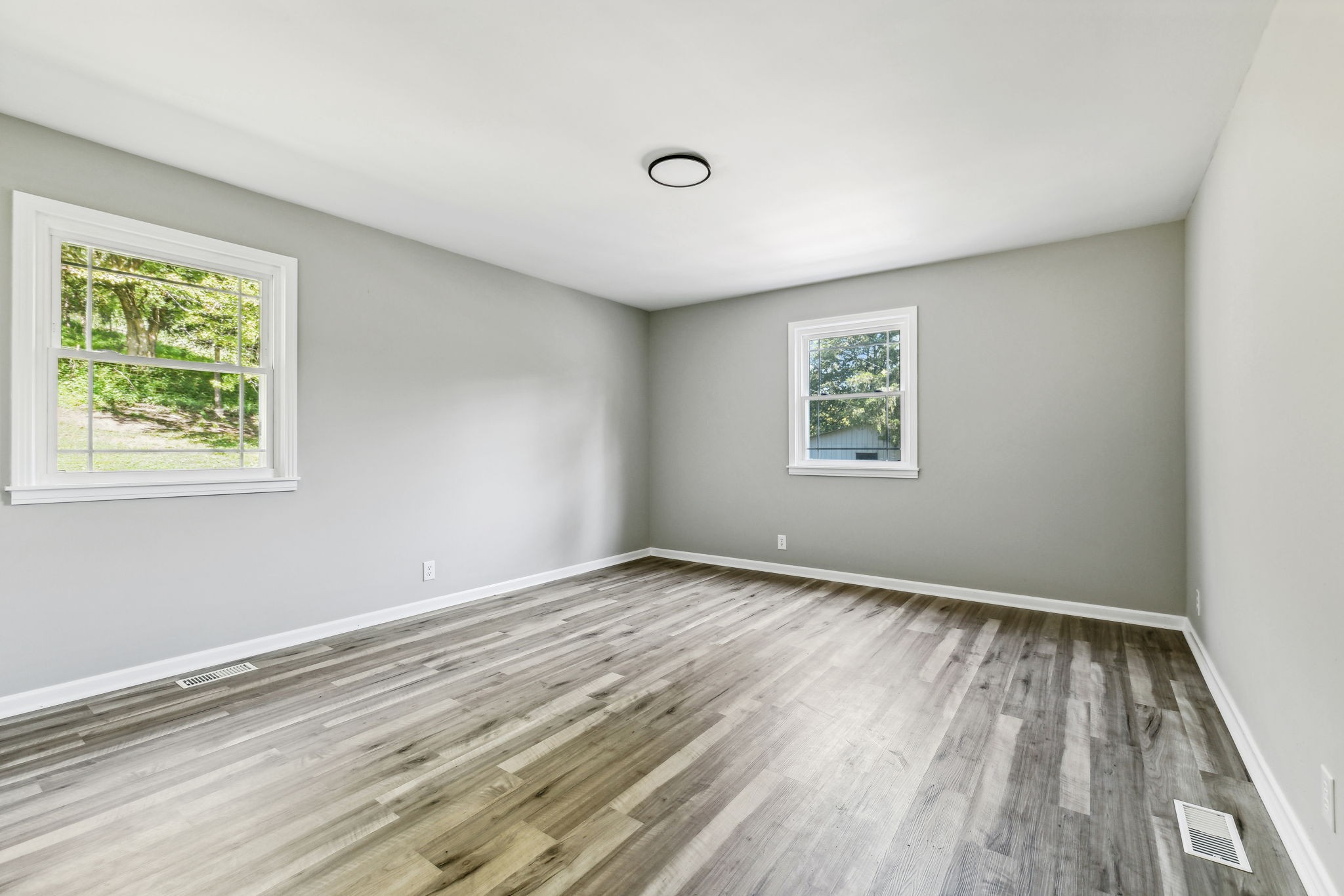87 Gladdice Road Pleasant Shade, TN 37145 - Photo 24 of 47 a view of an empty room with wooden floor and a window
