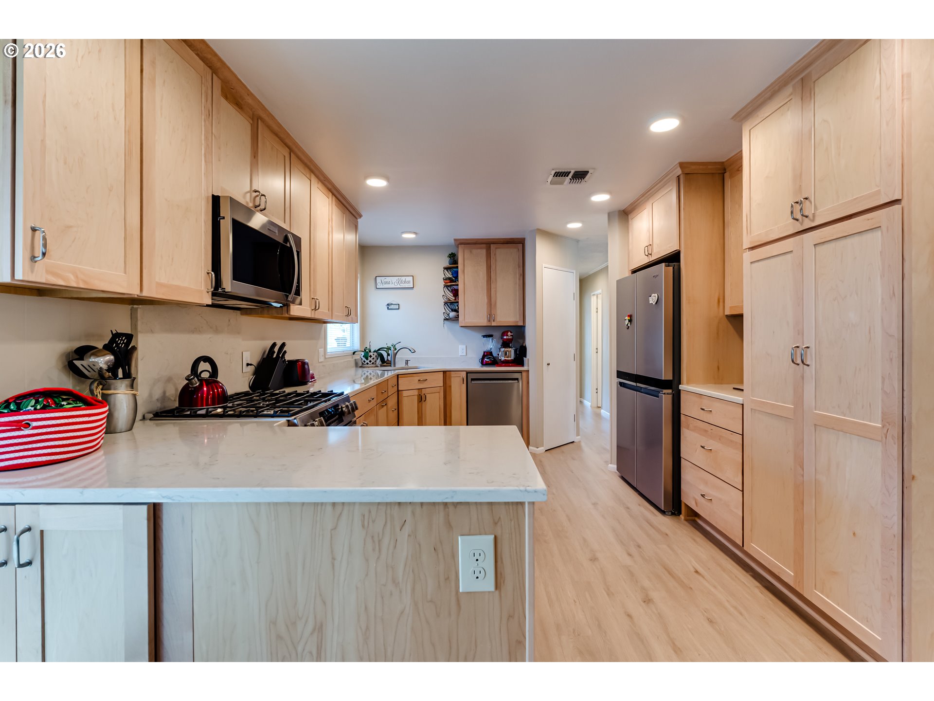 34681 Devonshire Drive Eugene, OR 97405 - Photo 12 of 34 a kitchen with refrigerator a microwave a sink and cabinets