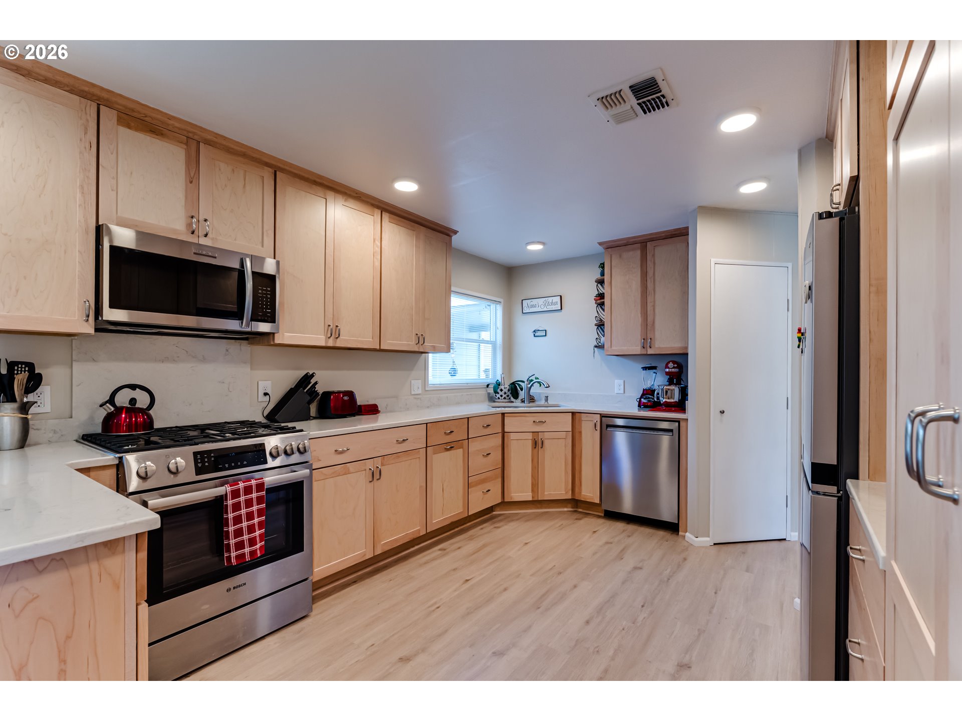 34681 Devonshire Drive Eugene, OR 97405 - Photo 13 of 34 a kitchen with granite countertop a stove top oven and cabinets