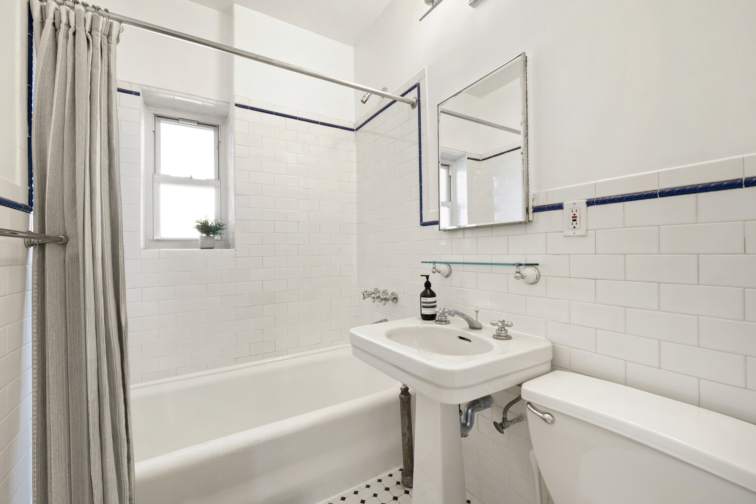 232 East 6th Street, Unit 6E Manhattan, NY 10003 - Photo 6 of 7 a bathroom with a sink a toilet and shower