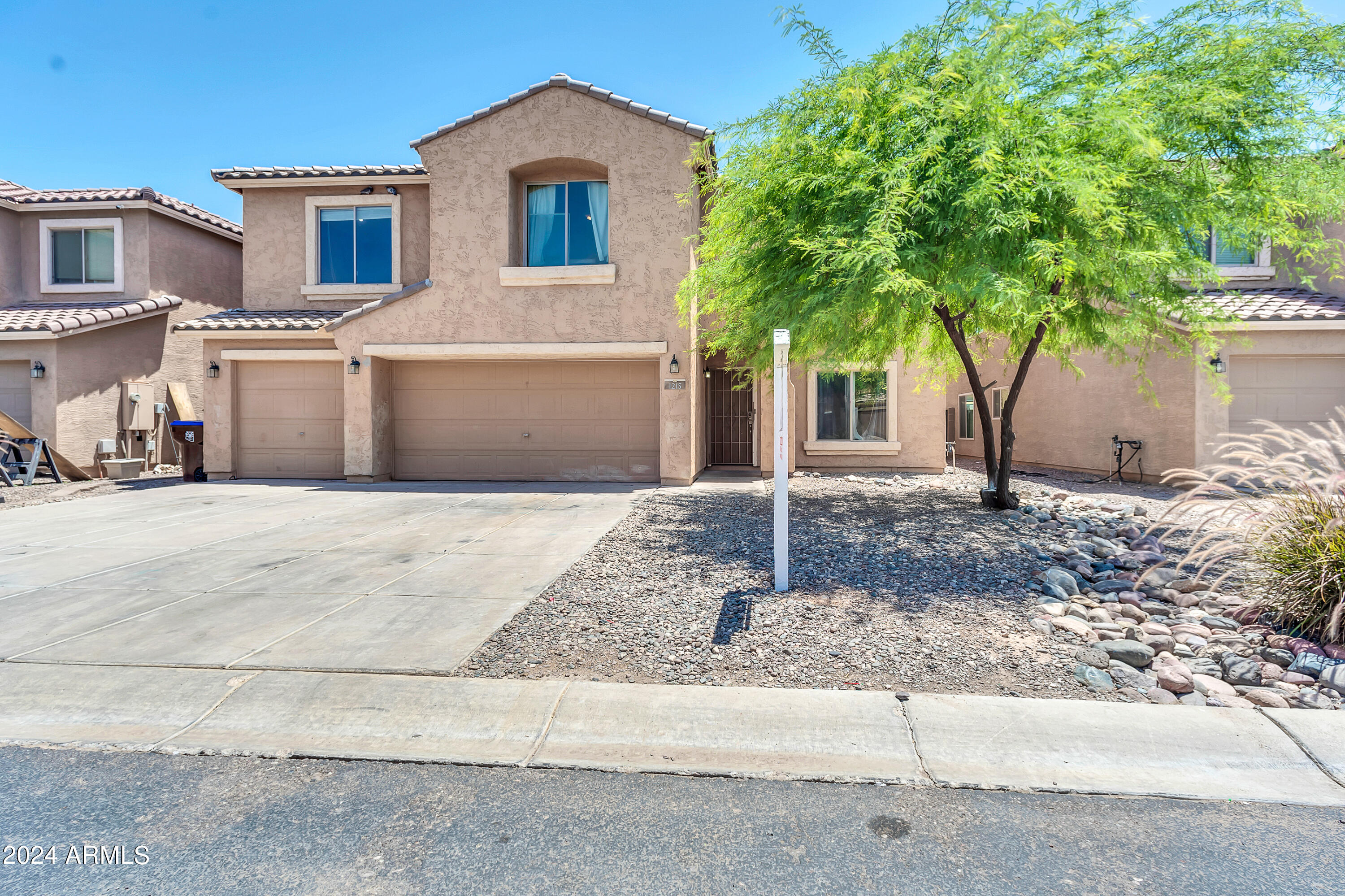 1215 West Ocotillo Street Coolidge, AZ 85128 - Photo 1 of 29 a front view of a house with garden