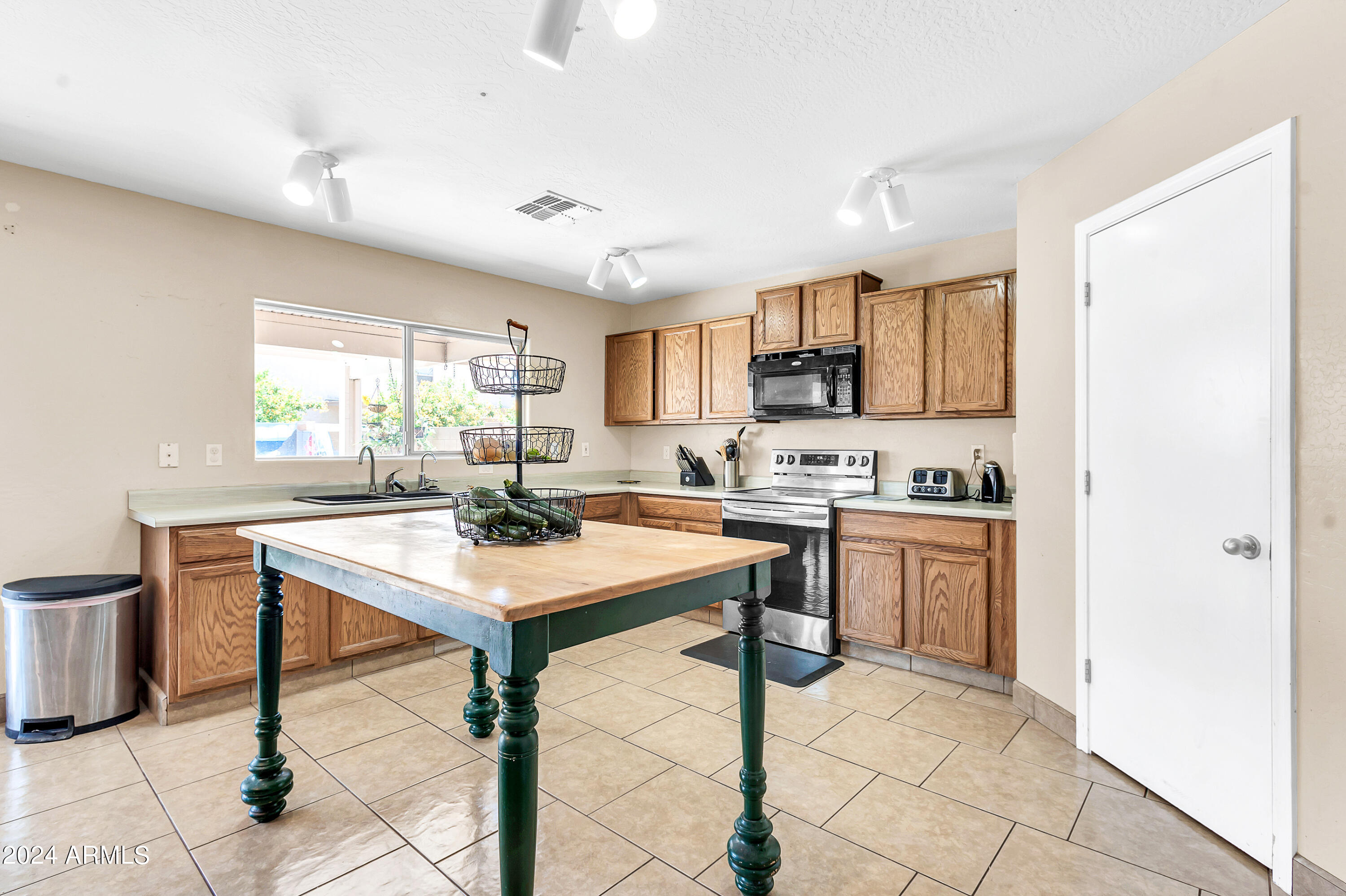 1215 West Ocotillo Street Coolidge, AZ 85128 - Photo 11 of 29 a view of kitchen with sink refrigerator dining table and chairs