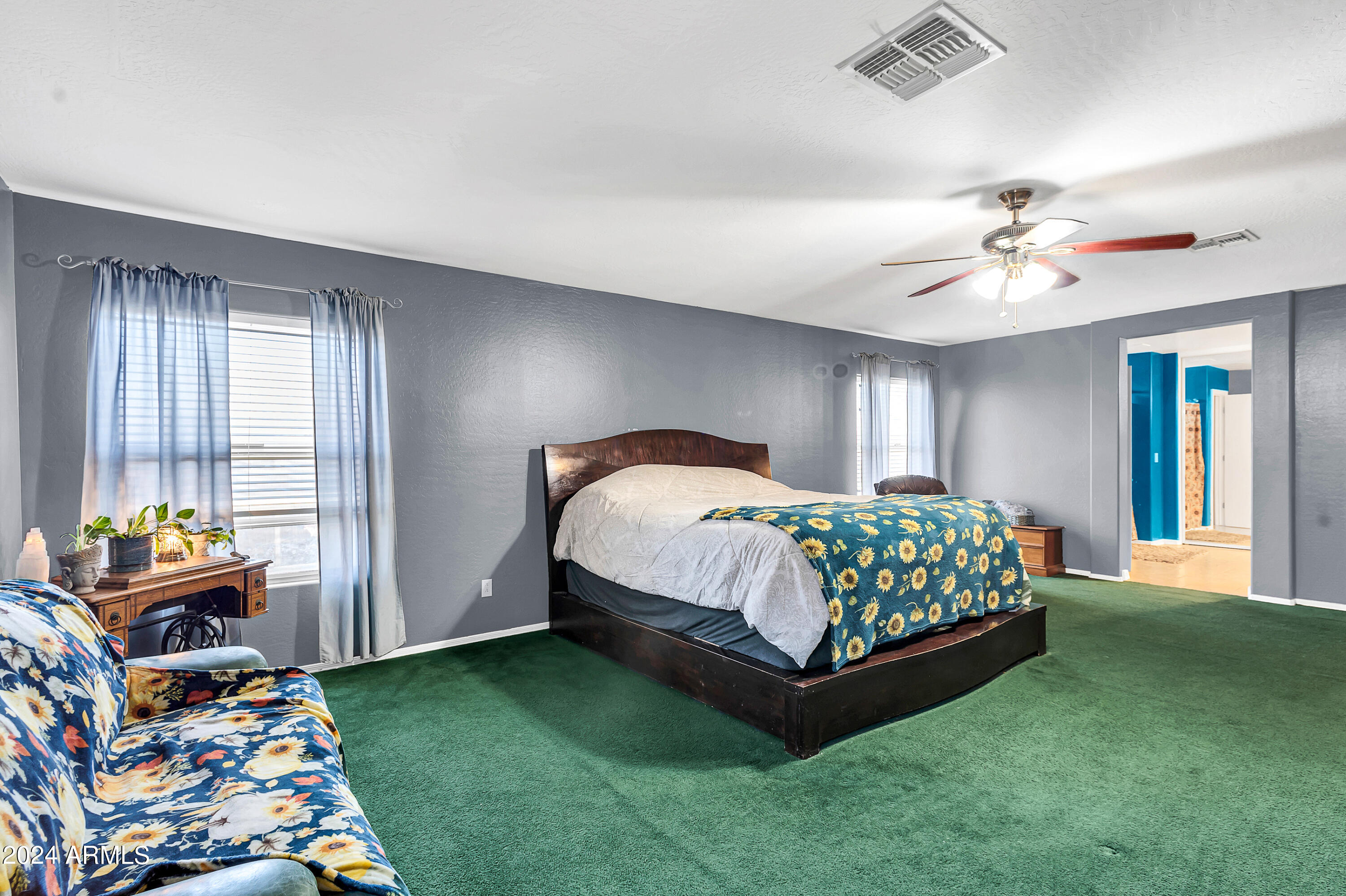 1215 West Ocotillo Street Coolidge, AZ 85128 - Photo 13 of 29 a bedroom with a bed and a chandelier