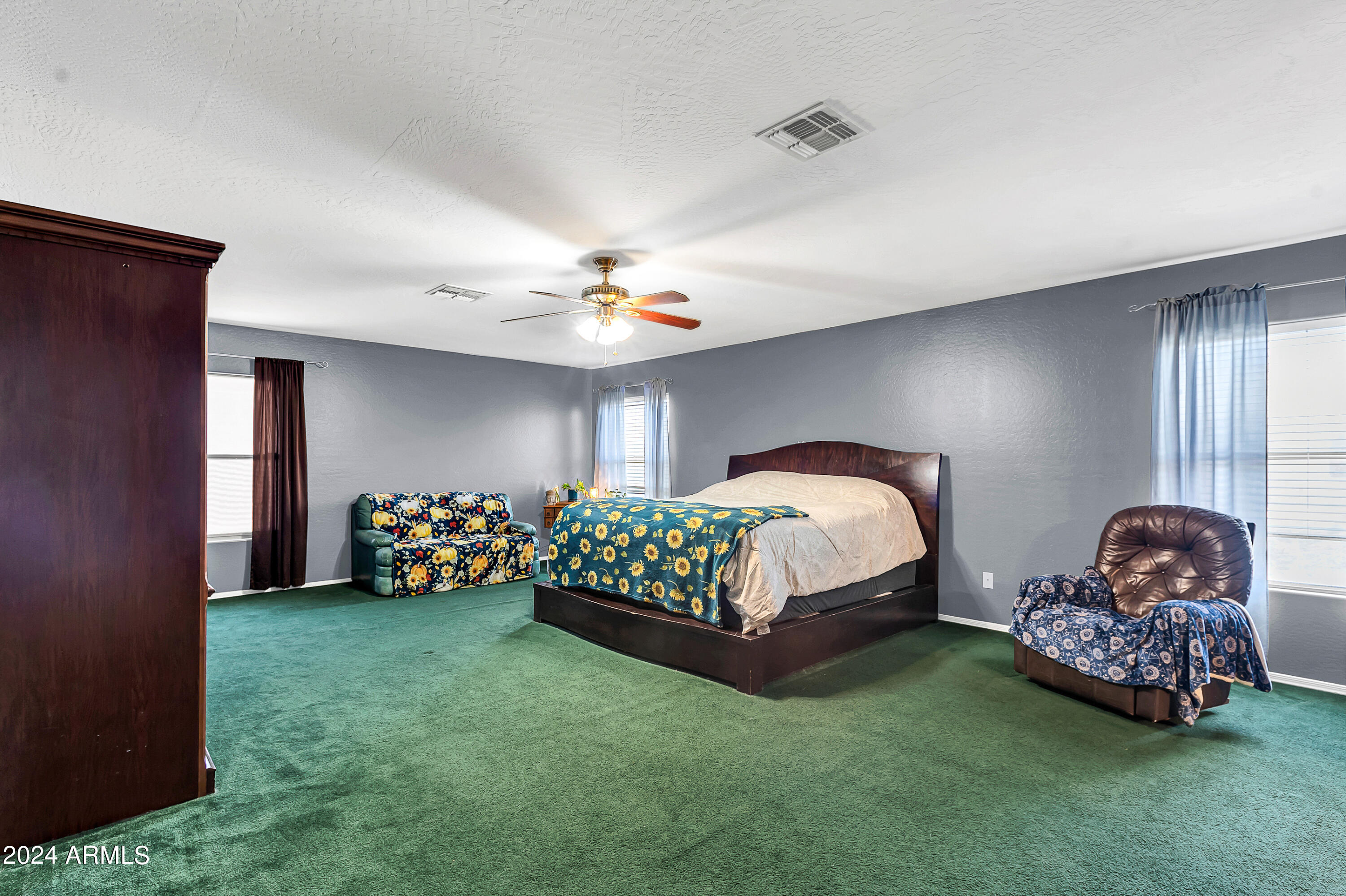 1215 West Ocotillo Street Coolidge, AZ 85128 - Photo 15 of 29 a bedroom with bed and a chandelier