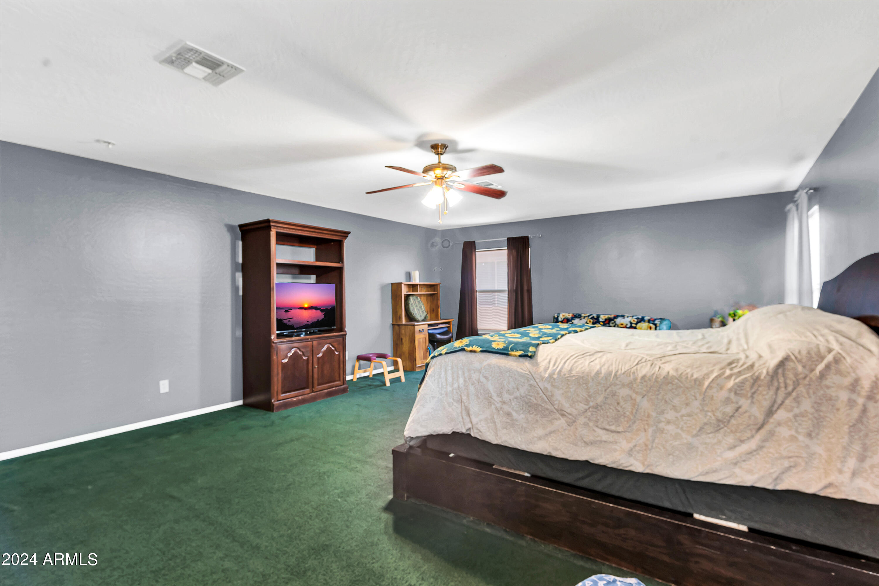 1215 West Ocotillo Street Coolidge, AZ 85128 - Photo 16 of 29 a spacious bedroom with a bed and a chandelier
