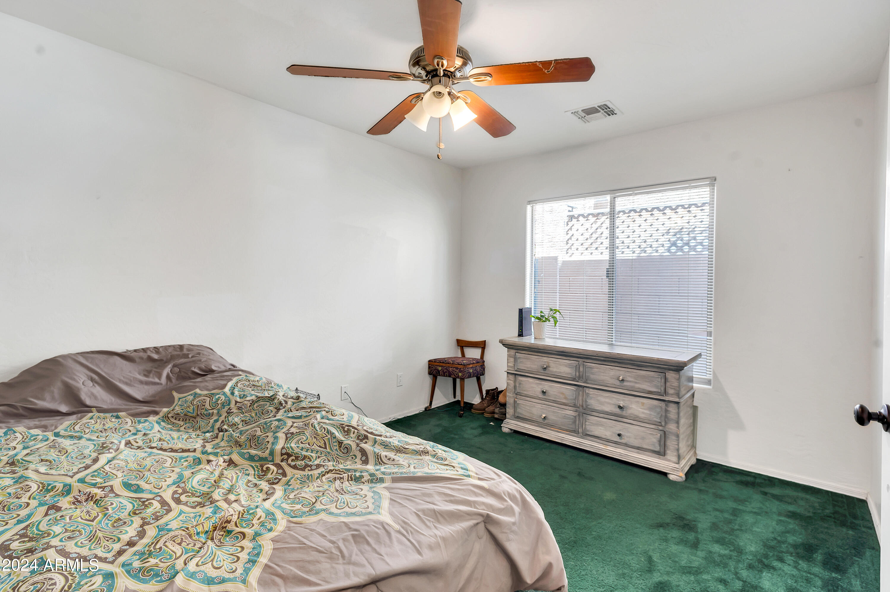 1215 West Ocotillo Street Coolidge, AZ 85128 - Photo 21 of 29 a bedroom with a bed and a chandelier