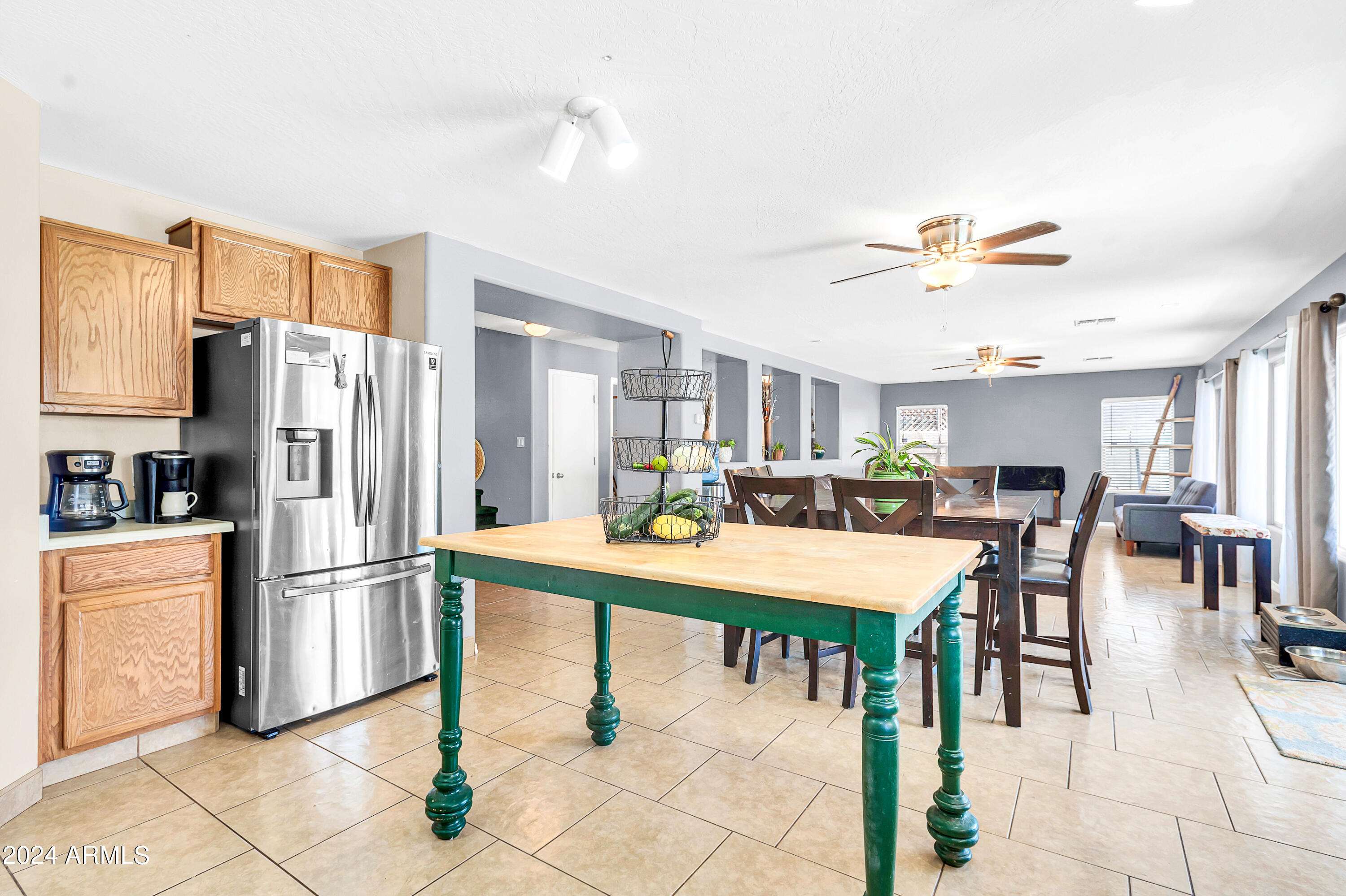 1215 West Ocotillo Street Coolidge, AZ 85128 - Photo 4 of 29 a kitchen with stainless steel appliances refrigerator dining table and chairs