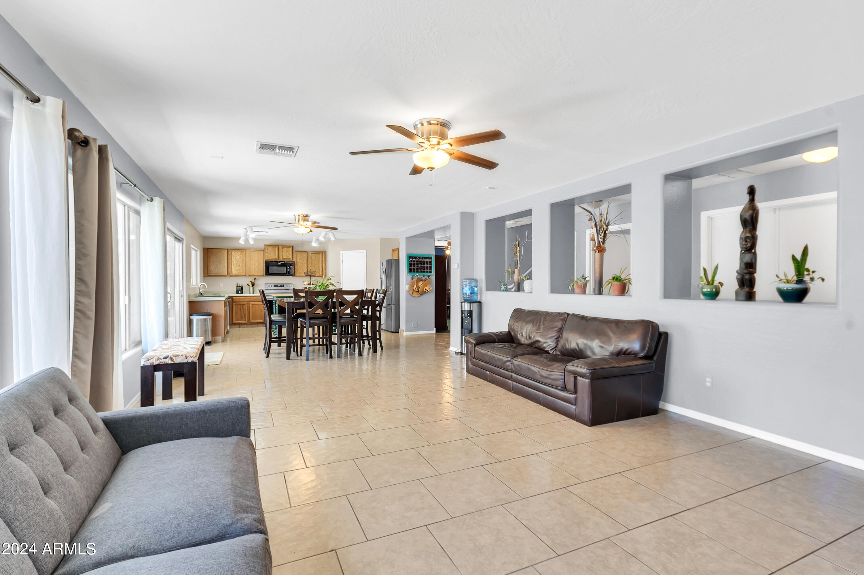 1215 West Ocotillo Street Coolidge, AZ 85128 - Photo 6 of 29 a living room with furniture a dining table and a chandelier