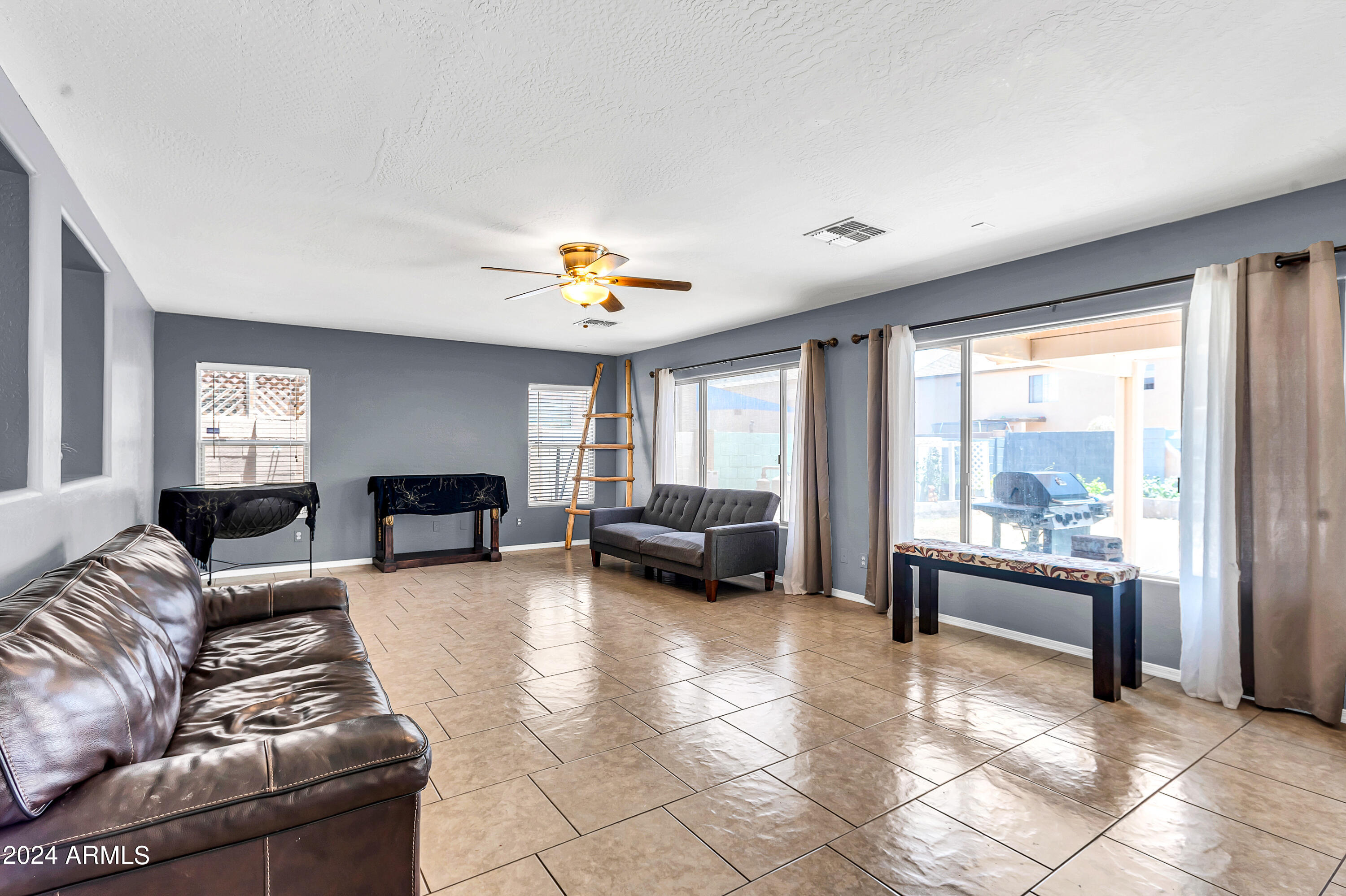 1215 West Ocotillo Street Coolidge, AZ 85128 - Photo 7 of 29 a living room with furniture and a large window
